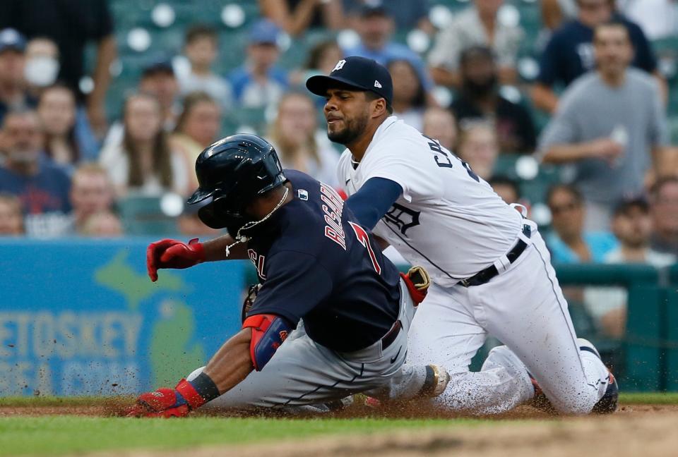 Guardians shortstop Amed Rosario is tagged out by Tigers third baseman Jeimer Candelario while trying to stretch a double into a triple during the fourth inning on Tuesday, Aug. 9, 2022, at Comerica Park.