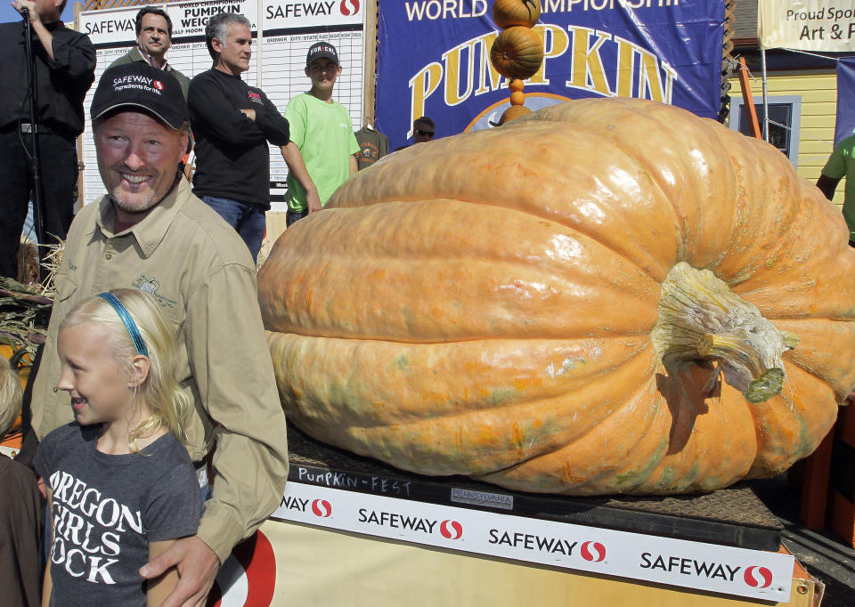 Thad Starr from Pleasant Hill, Ore. celebrates with his daughter Danika, 9, after winning the Half Moon Bay Pumpkin Festival Weigh-off contest in Half Moon Bay, Calif., Monday, Oct. 8, 2012. The pumpkin weighed 1,775 pounds, making it a new California record. Starr wins six dollars for each pound, which equals $10,650. (AP Photo/Tony Avelar)