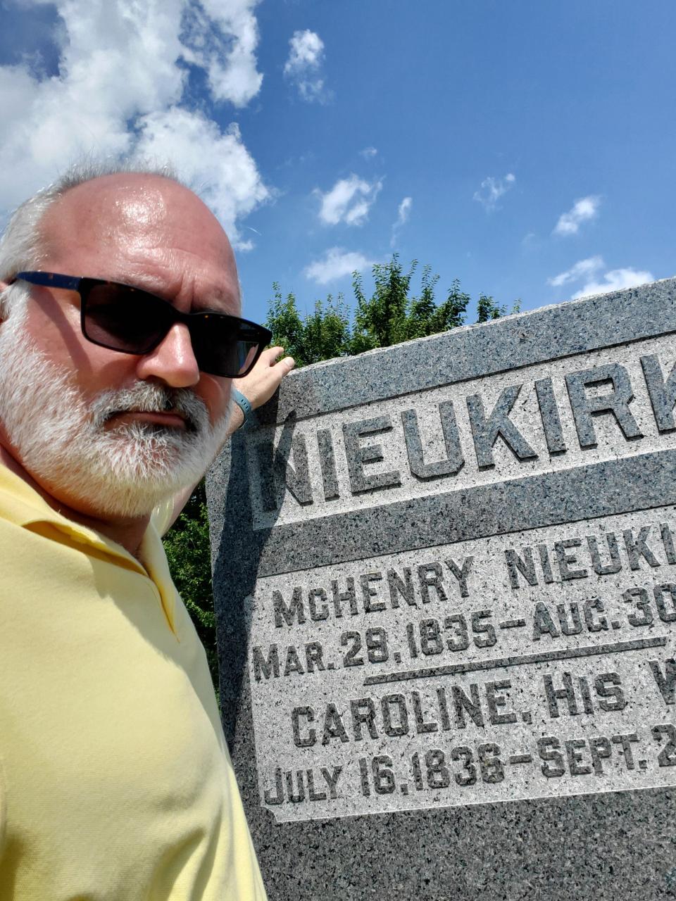 Dr. Ronald Gaitros, formerly of Pekin, looks over a gravestone at Haines Cemetery that has piqued his curiosity since boyhood.