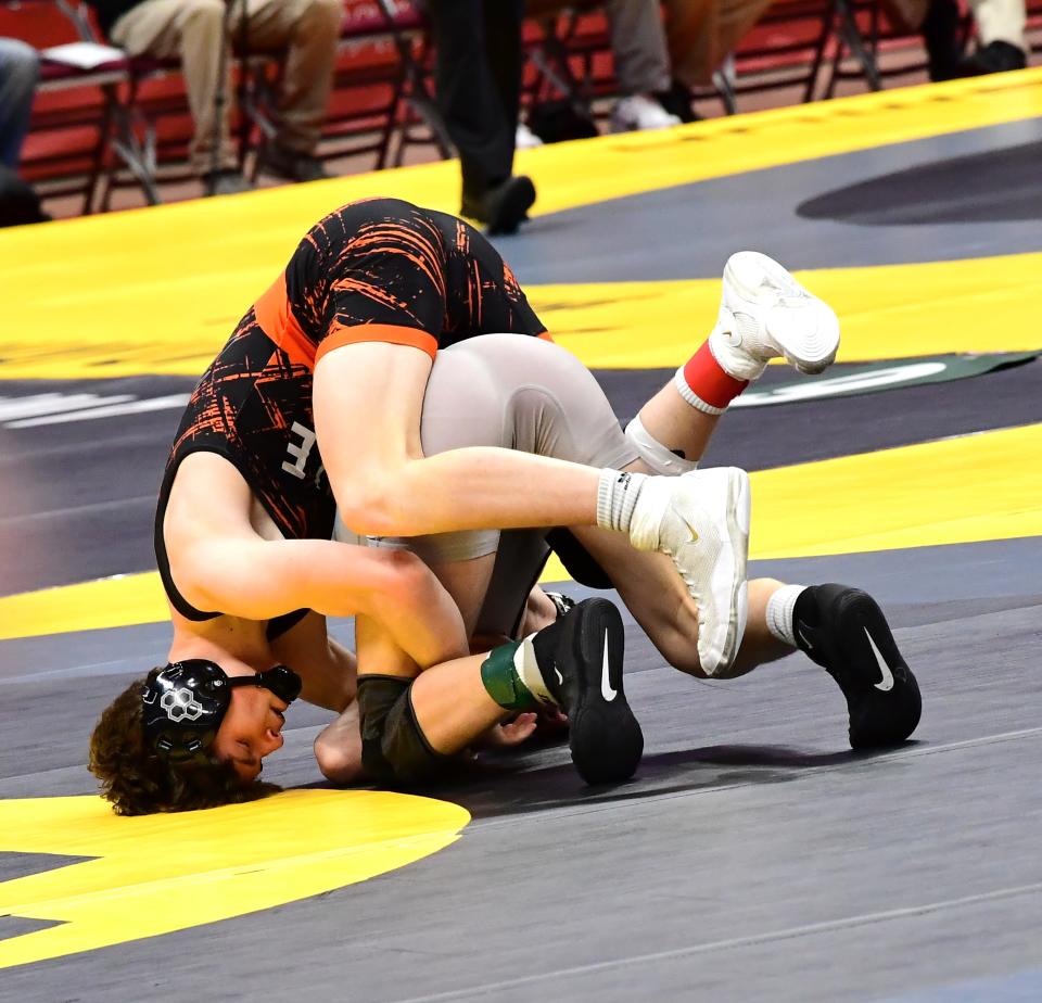 Mark Ellis (left) of Waynesville wrestles in the first round in Division III at 138 pounds at the OHSAA 86th annual boys wrestling state tournament March 10-12, 2023.