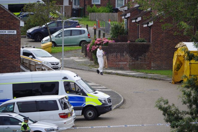 A forensic officer carries an evidence bag in Biddick Drive in the Keyham area of Plymouth, Devon (ben Birchall/PA)