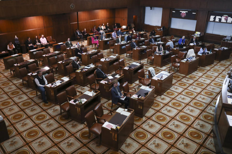 Senators sit at their desks during a session at the Oregon State Capitol in Salem, Ore., Thursday, May 4, 2023. Four Republican senators and one Independent senator had unexcused absences, preventing a quorum for the second day. (AP Photo/Amanda Loman)