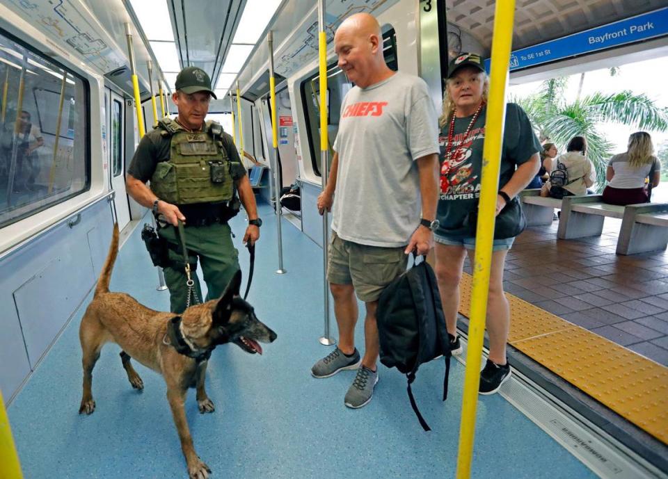 Miami-Dade police K-9 Unit officer Ray Robertson works with police dog Aimee at the Metromover station at Bayfront Park in Miami on Saturday. TSA is partnering with law enforcement agencies to increase security at transit stations during Super Bowl weekend in Miami.