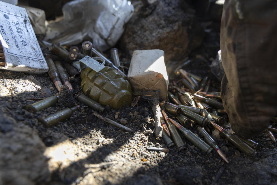 FILE - A grenade and bullets are seen in the trenches at the front line a few kilometers from Andriivka, Donetsk region, Ukraine, Saturday, September 16, 2023. A gloomy mood hangs over Ukraine’s soldiers nearly two years after Russia invaded their country. Ukrainian soldiers remain fiercely determined to win, despite a disappointing counteroffensive this summer and signs of wavering financial support from allies. (AP Photo/Alex Babenko, File)