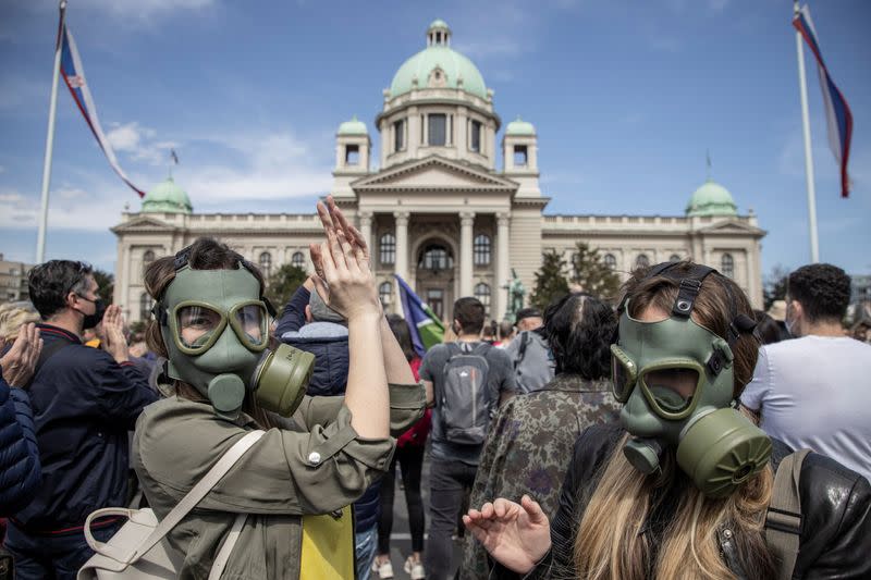 People attend a protest in front of the Serbian parliament in Belgrade