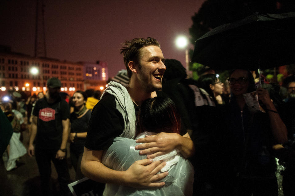 Mike Price, a 24-year-old arrested Sunday, hugs a friend as he walks out of the St. Louis City Justice Center after his release Monday.