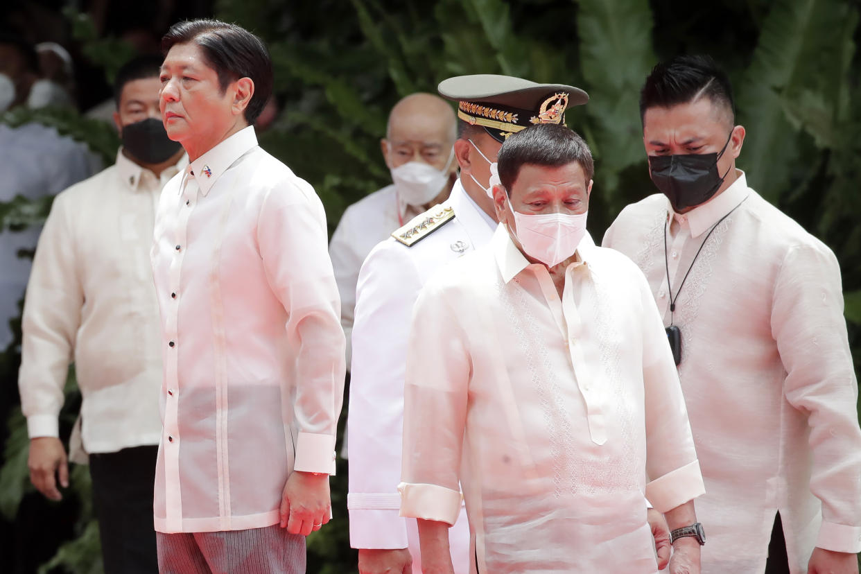 FILE PHOTO: Incumbent Philippine President Ferdinand Marcos Jr., left, and former President Rodrigo Duterte, right, attend Marcos' inauguration ceremony at the Malacañang Presidential Palace grounds in Manila, Philippines, Thursday, June 30, 2022. (Francis R. Malasig/Pool Photo via AP)