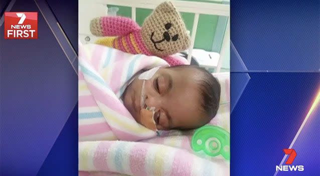 Sick baby Yusra with her knitted trauma teddy. Source: 7 News