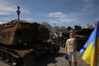 People visit an open-air exhibition of damaged and burnt-out Russian tanks and armored vehicles at the Castle Square, in Warsaw, Poland, Monday, June 27, 2022. The vehicles were captured by Ukrainian military forces during the war in the Ukraine. Ukrainian authorities announced that there are plans for similar exhibits in other European capitals such as Berlin, Paris, Madrid and Lisbon. (AP Photo/Michal Dyjuk)