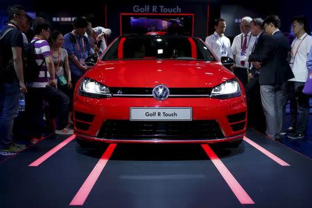 Attendees look at a Volkswagen Golf R Touch car during the 2015 International Consumer Electronics Show Asia in Shanghai, in this May 25, 2015 file picture. REUTERS/Aly Song/Files