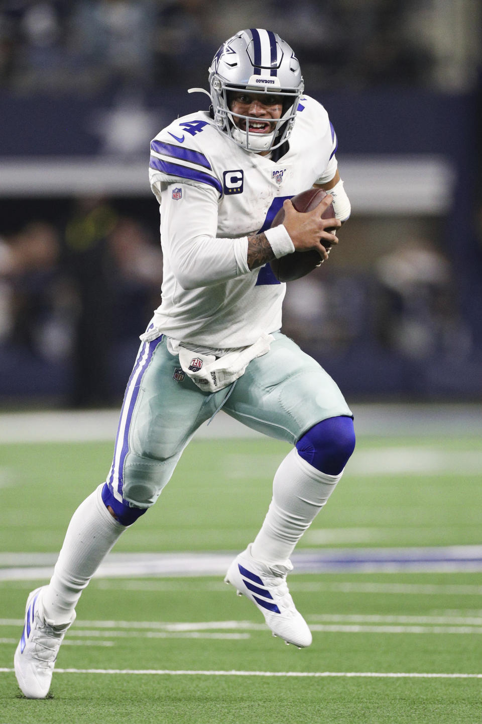 Dallas Cowboys quarterback Dak Prescott (4) scrambles with the ball in an NFL game against the Buffalo Bills, Thursday, Nov. 28, 2019 in Dallas. The Bills defeated the Cowboys 26-15. (Margaret Bowles via AP)