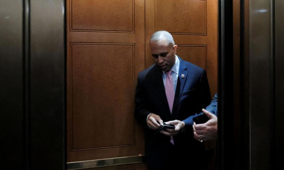 Hakeem Jeffries stands in front of a door.