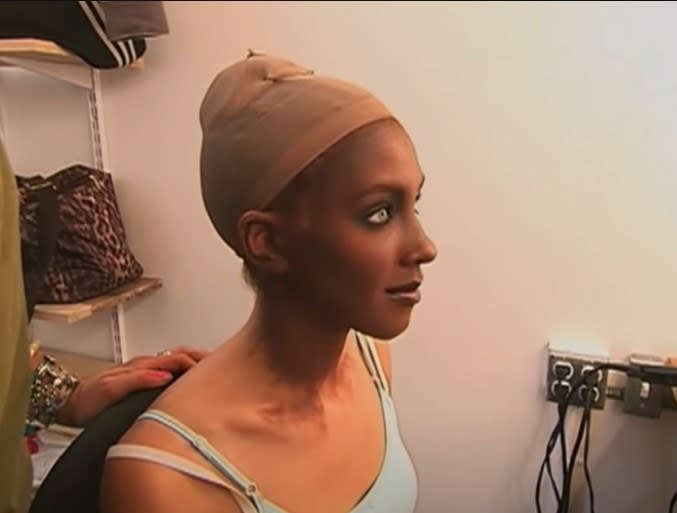 Model getting makeup done with excessive tanning to change her ethnicity in "America's Next Top Model"