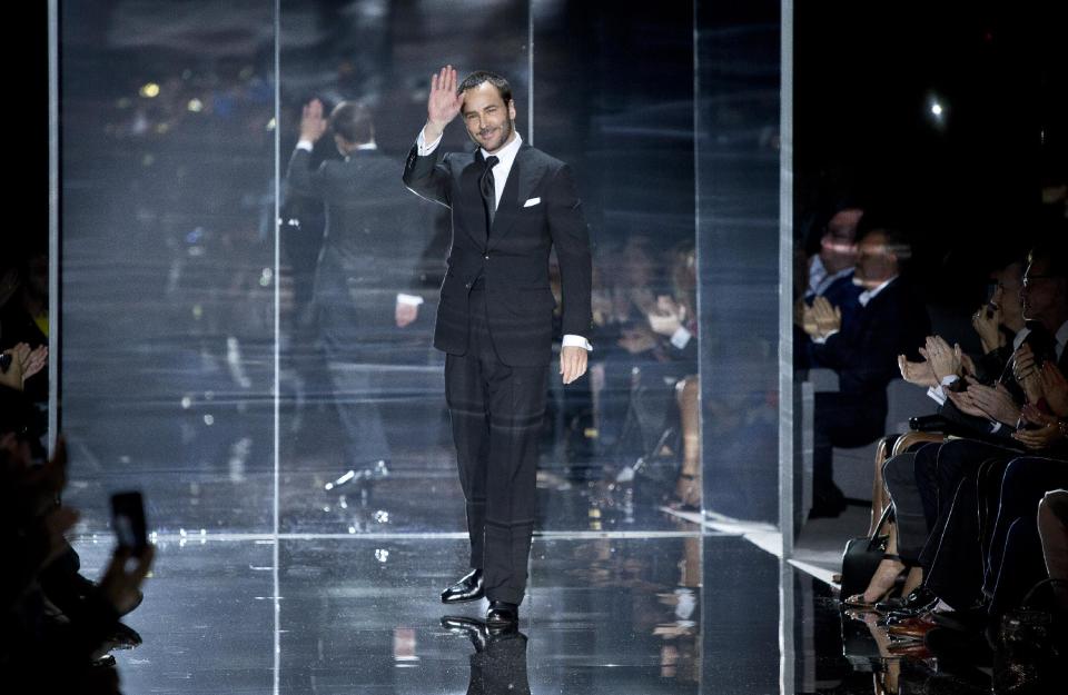 Tom Ford gestures as the crowd applaud following his show during London Fashion Week Spring/Summer 2014, at Lindley Hall, central London, Monday, Sept. 16, 2013. (Photo by Joel Ryan/Invision/AP)