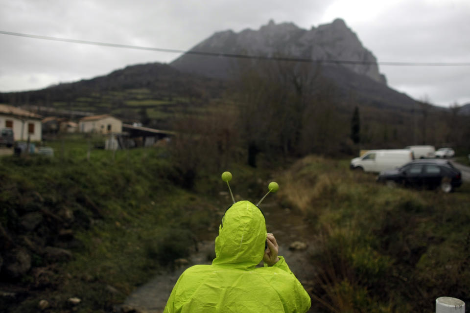 A woman dressed in an alien costume attends a small party in the town of Bugarach, France, Friday, Dec. 21, 2012. Although the long expected end of the Mayan calendar has come, the New Age enthusiasts have steered clear from the sleepy French town of Bugarach, which gave some locals a chance to joke about the UFO legends that surround the area. (AP Photo/Marko Drobnjakovic)