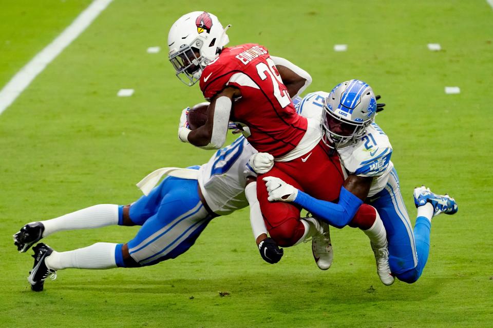 Cardinals running back Chase Edmonds is hit by Lions defensive back Tracy Walker and cornerback Jeff Okudah during the first half on Sunday, Sept. 27, 2020, in Glendale, Ariz.