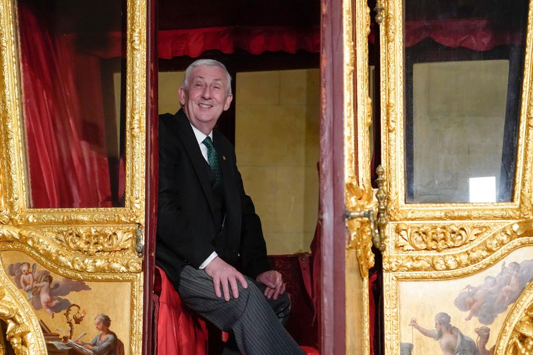 Britain's Speaker of the House of Commons Lindsay Hoyle sits in the Speaker's State Coach as it returns to Westminster, ahead of the coronation of Britain's King Charles III, in London, Sunday, April 30, 2023. The gilded coach, which was last seen in the historic Westminster Hall in 2005, will be on display once again from 2 May to the Autumn, to commemorate the crowning of King Charles III. (AP Photo/Alberto Pezzali)