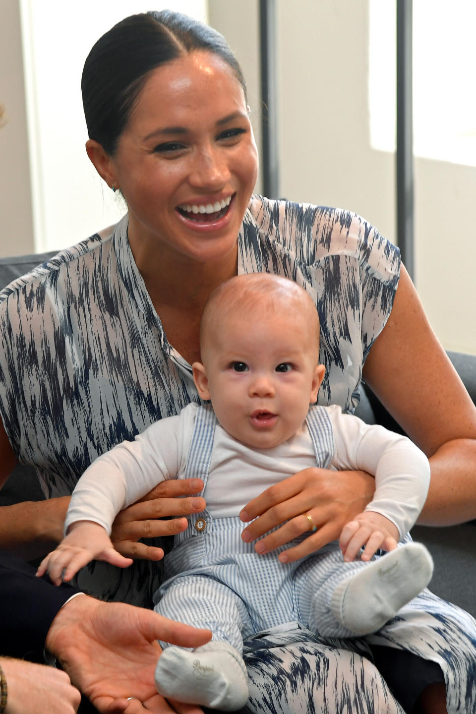 Meghan Markle holds Archie as they meet Archbishop Desmond Tutu in Cape Town, South Africa.