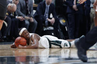 Michigan State's Cassius Winston smiles after hitting the floor on a scramble for the ball against Iowa during the second half of an NCAA college basketball game, Tuesday, Feb. 25, 2020, in East Lansing, Mich. Michigan State won 78-70. (AP Photo/Al Goldis)