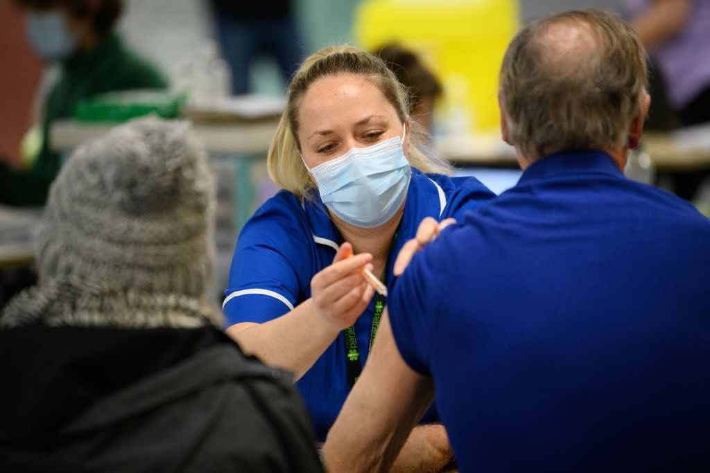 <p>Medical worker administers Covid-19 vaccination at NHS vaccination centre, as others are left in the dark as to when they will be inoculated</p> (Getty)