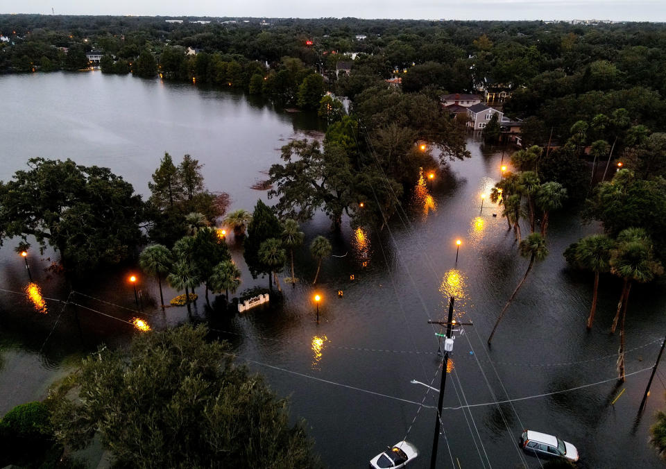 In an aerial view, floodwaters cover a large portion of a street.