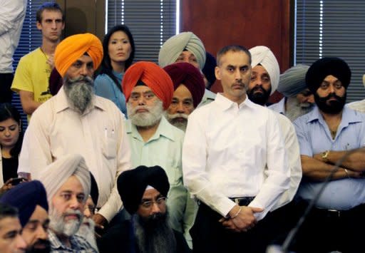 Members of Sikh community attend a press conference August 6, 2012 in Oak Creek, Wisconsin about the shootings Sunday at the Sikh Temple of Wisconsin. The FBI said Wade Michael Page, 40, had ties to white supremacist groups and had become subject of a "domestic terrorism" probe following the massacre at Oak Creek