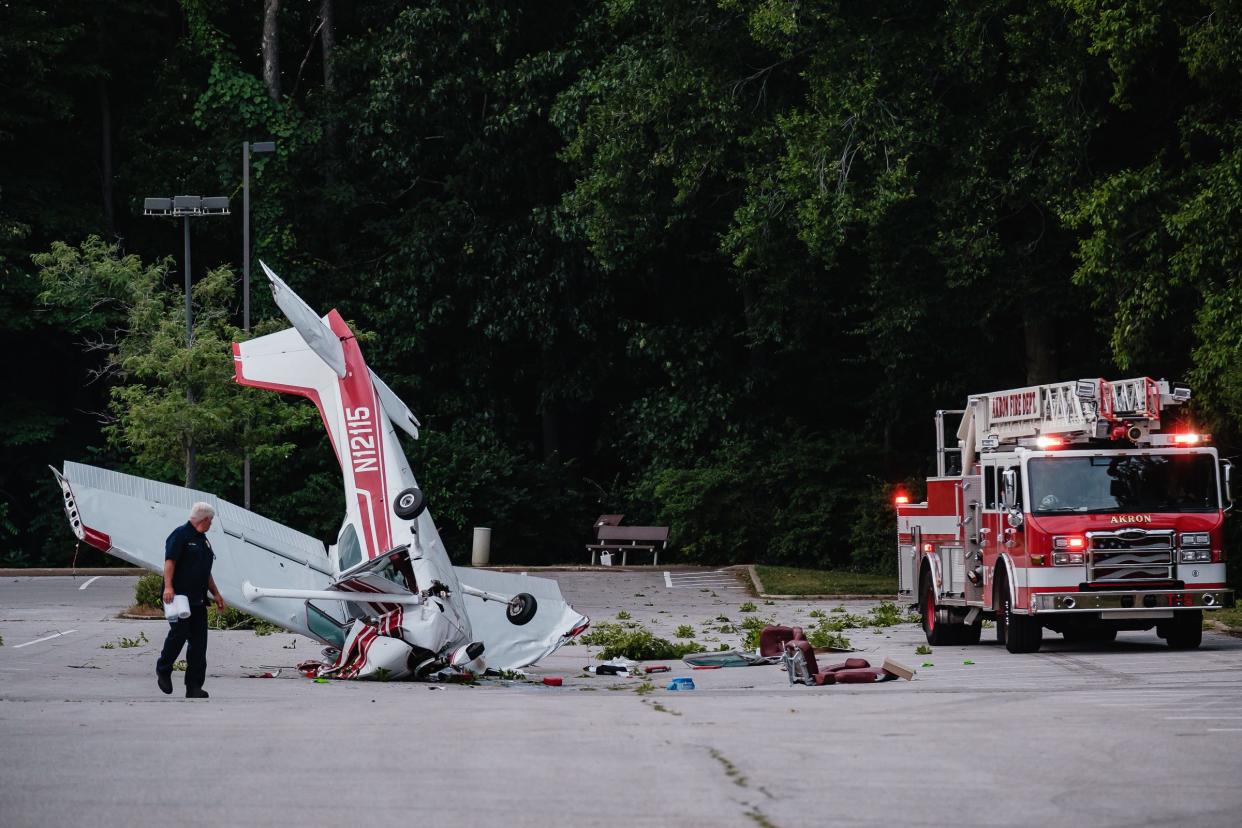 Akron firefighters respond to the scene of a plane crash where a single-piston Cessna Skyhawk went down Monday at Ellet Community Center in Akron.