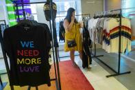 In this Thursday, June 20, 2019, photo a customer shows at the Pride and Joy shop in the Macy's flagship store in New York. For Pride month, retailers across the country are selling goods and services celebrating LGBTQ culture. (AP Photo/Mary Altaffer)