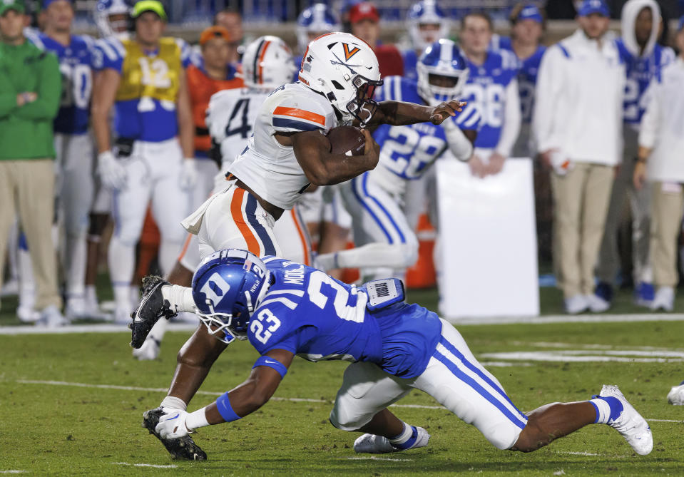 Virginia's Perris Jones avoids a tackle by Duke's Terry Moore (23) during the first half of an NCAA college football game in Durham, N.C., Saturday, Oct. 1, 2022. (AP Photo/Ben McKeown)