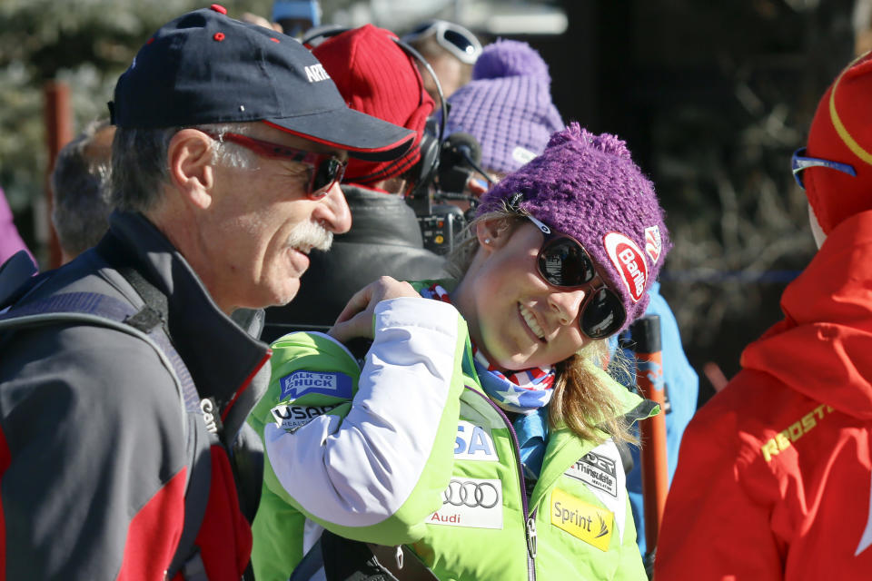 FILE - In this Nov. 23, 2012, file photo, Mikaela Shiffrin, center, talks with her ski technician, right, along with her father, Jeff Shiffrin, left, after a practice run for the women's World Cup ski race in Aspen, Colo. Not a day goes by that some image, moment or even song doesn't remind two-time Olympic gold medalist Mikaela Shiffrin of her dad, Jeff, who died February 2020, after an accident at his home in Colorado. (AP Photo/Nathan Bilow, FIle)