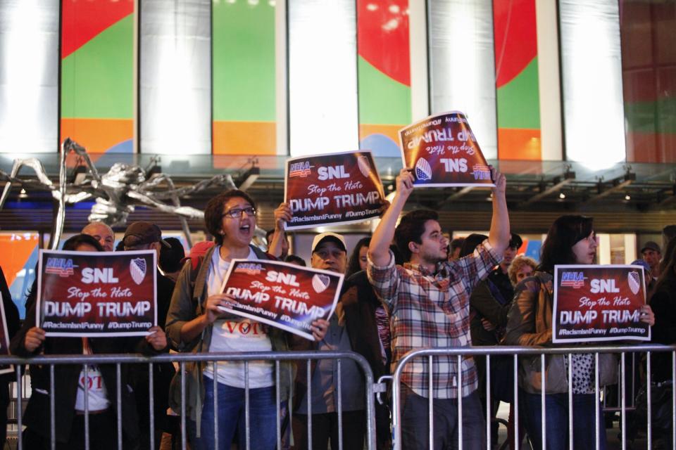 People protest in  front of NBC studios while they are calling for the network to rescind the invitation to Donald Trump to host Saturday Night Live show on November 4, 2015 in New York. 