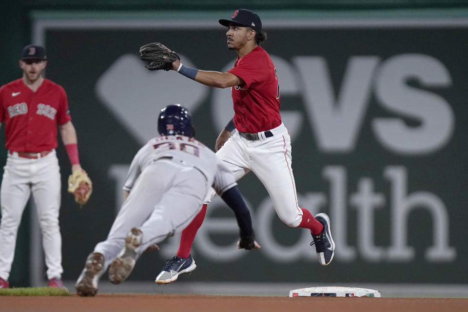 Houston Astros' Kyle Tucker slides while trying to steal second as Boston Red Sox's David Hamilton, top right, prepares to tag him for the out during the sixth inning of a baseball game Tuesday, Aug. 29, 2023, in Boston. (AP Photo/Steven Senne)