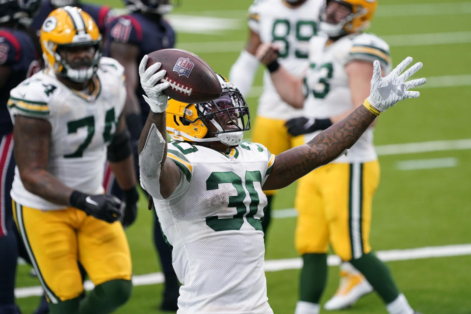 Green Bay Packers running back Jamaal Williams (30) celebrates after scoring during the second half of an NFL football game against the Houston Texans Sunday, Oct. 25, 2020, in Houston. (AP Photo/Sam Craft)