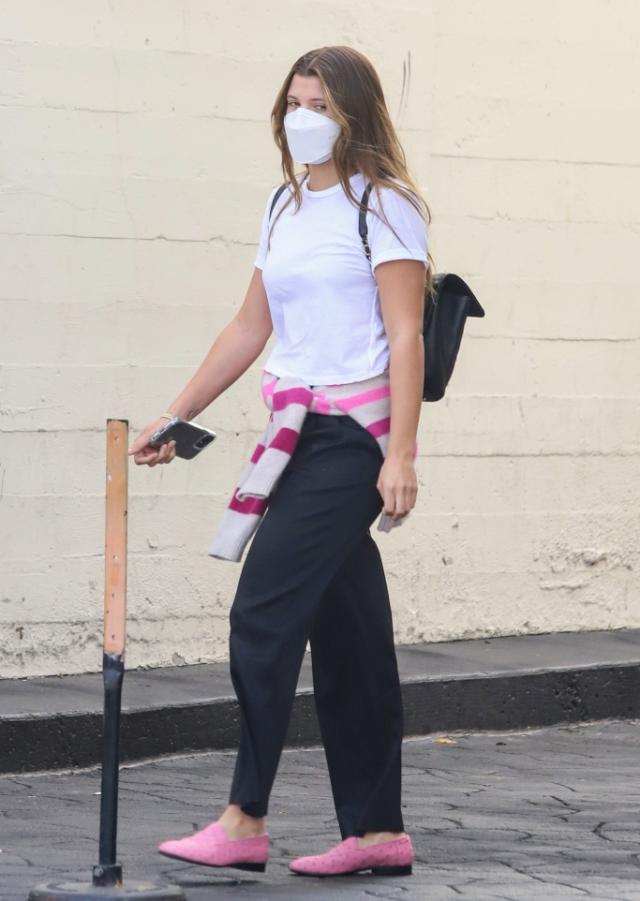 Sofia Richie wears a pink top and flared black pants while out for lunch  with her
