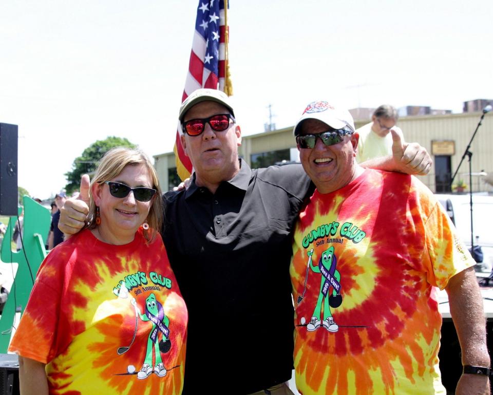 Denise Roseff (left) and Rob Roseff (right.) In the center is Rob's college roommate, Tom "Mel" Stanton.  Mel is the executive director of Mel's Charities in Ozaukee County and has helped the Roseffs grow the Gumby's charity.