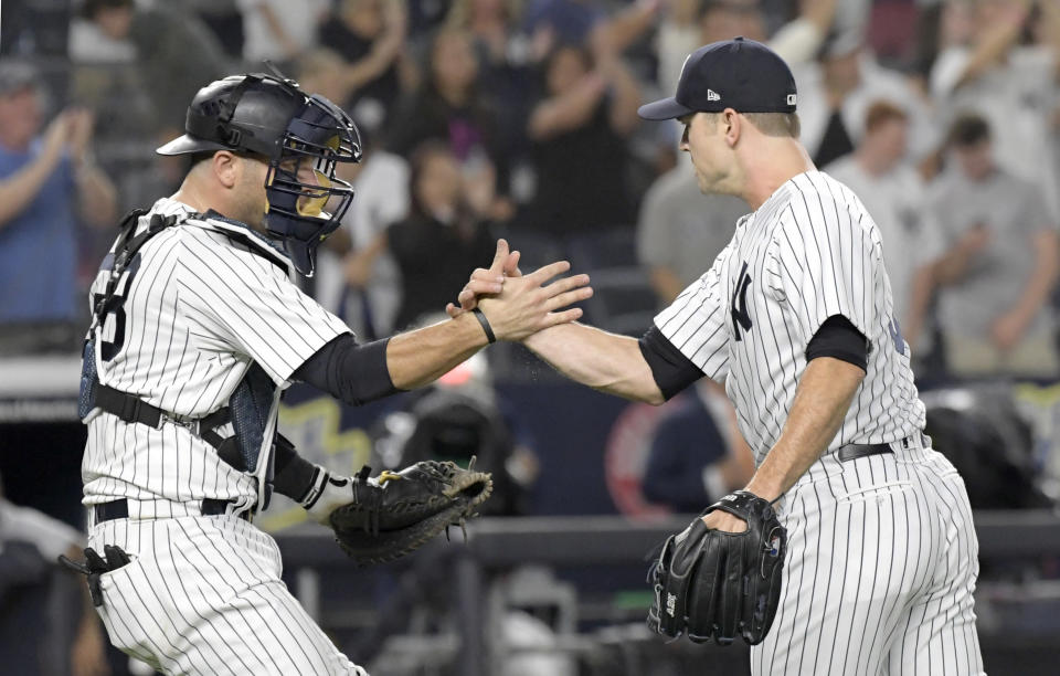 New York Yankees pitcher David Robertson, right, celebrates with catcher Austin Romine, left, after they defeated the Detroit Tigers in a baseball game Friday, Aug. 31, 2018, at Yankee Stadium in New York. (AP Photo/Bill Kostroun)