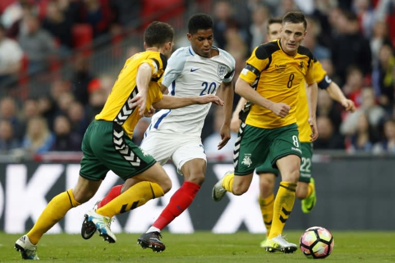 England's striker Marcus Rashford (C) runs through the challenges from Lithuania's defenders Tadas Kijanskas and Lithuania's Egidijus Vaitkunas (R) during a World Cup 2018 qualification match at Wembley Stadium