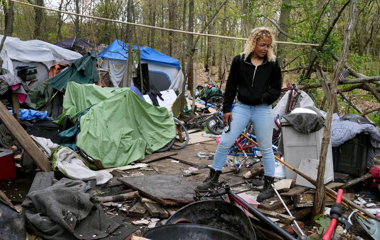 Surrounded by the tents and tarps and donated and salvaged items that help make living in the woods slightly more comfortable, Dawn Barnett stands among the encampment where she and a friend reside in the north end of Providence.