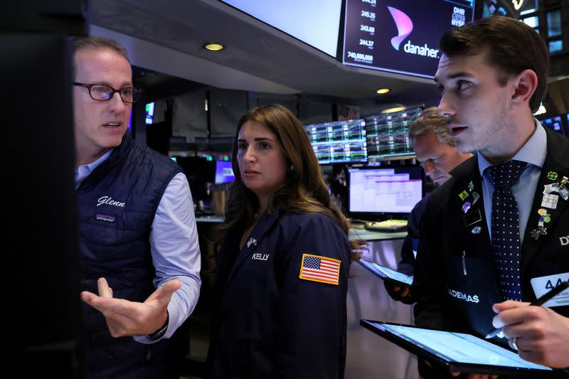 Traders work on the floor of the NYSE in New York