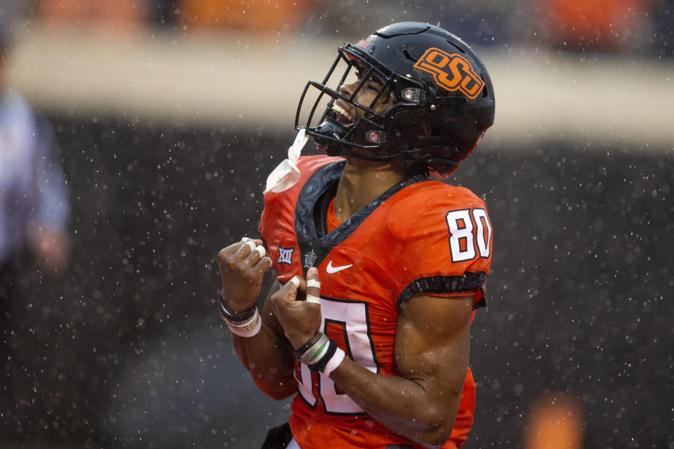 Oklahoma State wide receiver Brennan Presley celebrates during the second half of the NCAA college football game against West Virginia in Stillwater, Okla., Saturday Nov. 26, 2022. (AP Photo/Mitch Alcala)