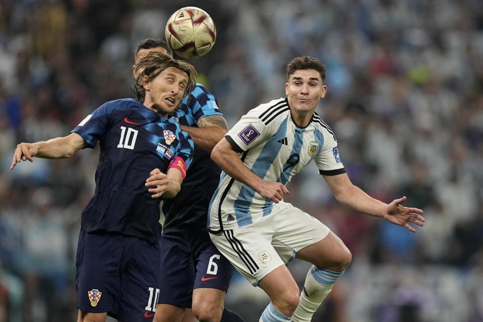 Argentina's Julian Alvarez, right, and Croatia's Luka Modric challenge for the ball during the World Cup semifinal soccer match between Argentina and Croatia at the Lusail Stadium in Lusail, Qatar, Tuesday, Dec. 13, 2022. (AP Photo/Martin Meissner)