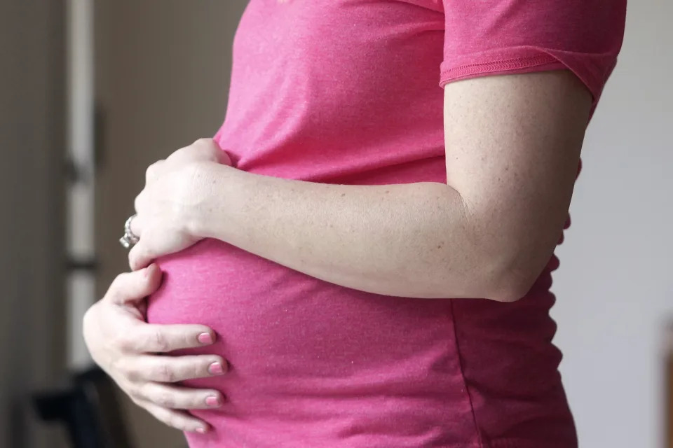 FILE - A pregnant woman stands for a portrait in Dallas, May 18, 2023. Complaints about pregnant women being turned away from emergency rooms spiked in the months after states began enacting strict abortion laws following the 2022 U.S. Supreme Court decision overturning Roe v. Wade. The cases are detailed in federal documents obtained by The Associated Press and raise serious questions about the state of emergency pregnancy care in the U.S. (AP Photo/LM Otero, File)