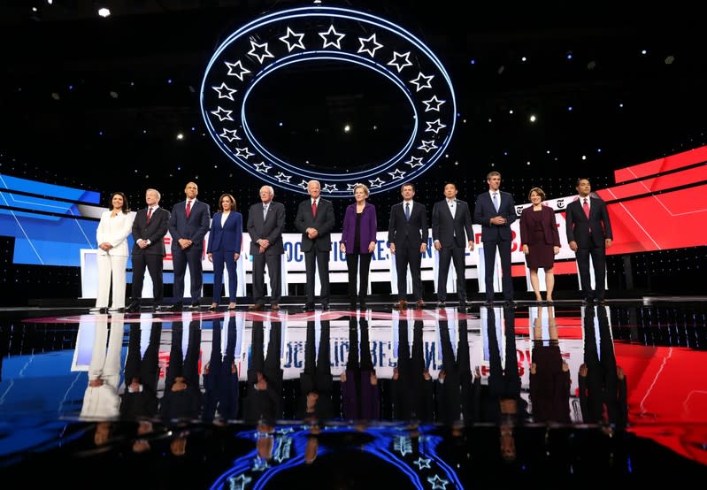 FILE PHOTO: Democratic presidential candidates pose together at the start of the fourth U.S. Democratic presidential candidates 2020 election debate at Otterbein University in Westerville, Ohio U.S.