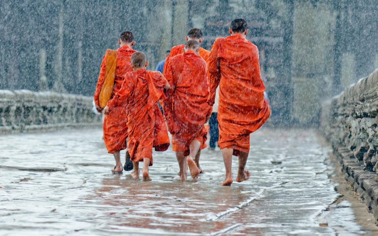 Monks brave the rain at Angkor Wat - GETTY