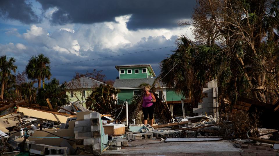 Debi Szekely searches through what remains of her home on Hibiscus Drive on Fort Myers Beach. The neighborhood was heavily impacted by Hurricane Ian. Many homes were destroyed and all of them sustained major flooding. She and her husband Tim were cleaning up and looking through the wreckage. They plan on rebuilding.