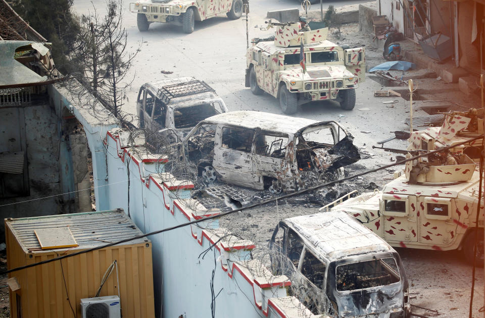 <p>Burnt vehicles are seen at the site of a blast and gun fire in Jalalabad, Afghanistan, Jan. 24, 2018. (Photo: Parwiz/Reuters) </p>