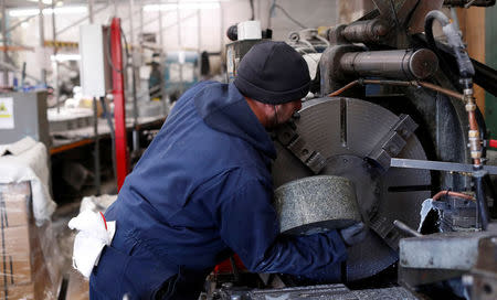 Kays Factory worker Allan Walsh puts granite on the lathe to make a curling stone in Mauchline, Scotland, Britain, January 11, 2018. REUTERS/Russell Cheyne