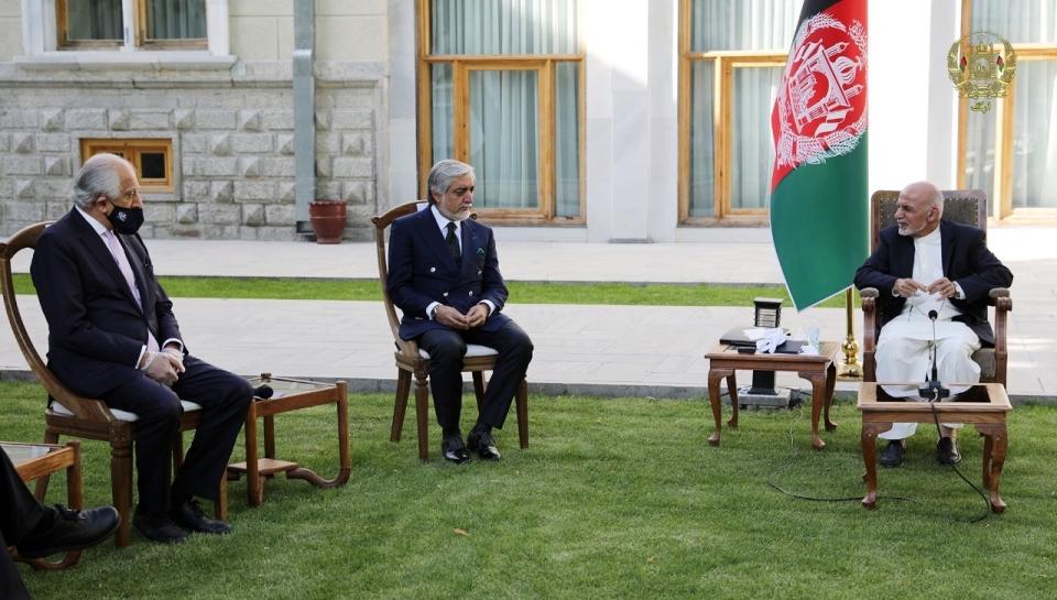 In this Wednesday, May 20, 2020 photo, Afghan President Ashraf Ghani, right, and fellow leader under a recently signed power-sharing agreement, Abdullah Abdullah, center, hold a meeting with U.S. peace envoy Zalmay Khalilzad aimed at resuscitating a U.S.-Taliban peace deal signed in February, at the Presidential Palace, in Kabul, Afghanistan. (The Presidential Palace via AP)