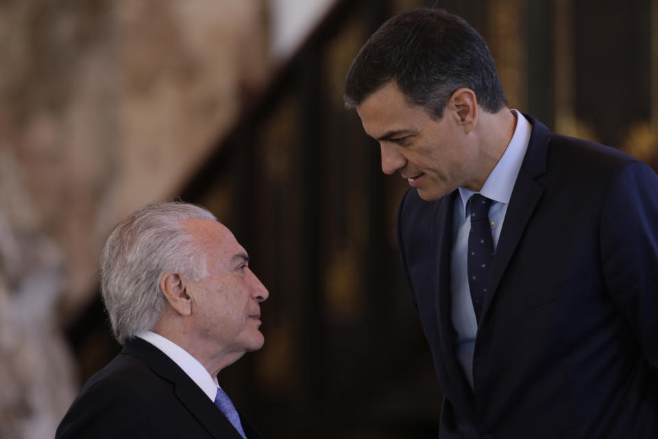 Brazil's President Michel Temer, left, and Spain's Prime Minister Pedro Sanchez, talk as they gather for a group photo during the XXVI Ibero-American Summit in Antigua, Guatemala, Friday, Nov. 16, 2018. The summit comes as waves of people are migrating from Venezuela and Central America to flee poverty, violence and political persecution. The leaders are set to discuss issues such as development and the economy. (AP Photo/Moises Castillo)