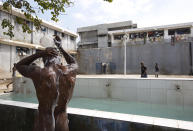 <p>A prisoner bathes during recreation time inside the National Penitentiary in downtown Port-au-Prince, Haiti, Feb. 13, 2017 . Inmates, some waiting up to eight years to see a judge, try to keep their sanity by maintaining a daily routine. (Photo: Dieu Nalio Chery/AP) </p>